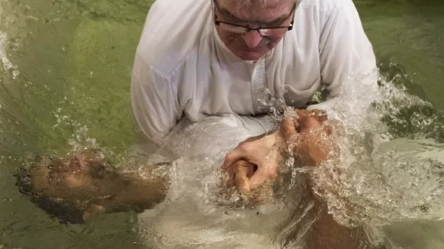 pastor matthias linke of the evangelisch freikirchliche gemeinde church baptizes a newly converted muslim refugee during a ceremony in berlin on november 27 2016 photo afp pastor matthias linke of the evangelisch freikirchliche gemeinde church baptizes a newly converted muslim refugee during a ceremony in berlin on november 27 2016 photo afp