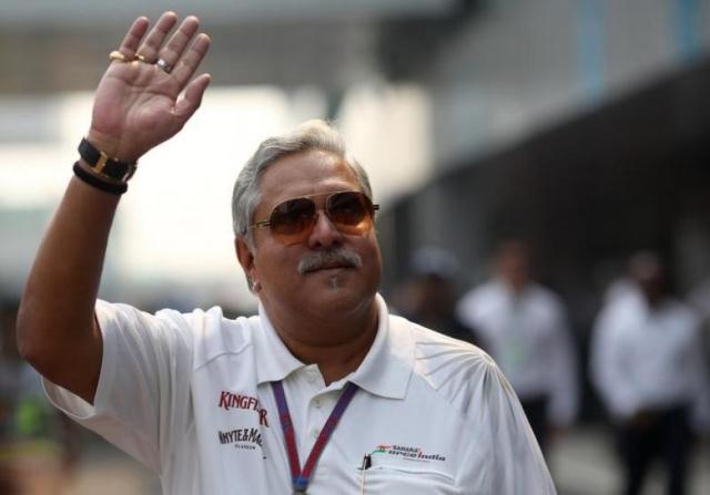 force india team principal vijay mallya waves in the paddock photo reuters