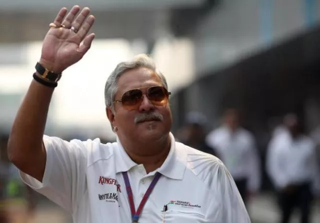 force india team principal vijay mallya waves in the paddock photo reuters force india team principal vijay mallya waves in the paddock photo reuters