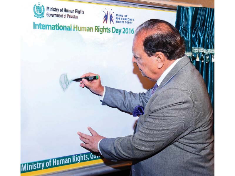 president mamnoon hussain signs a board on the occasion of international human rights day photo inp