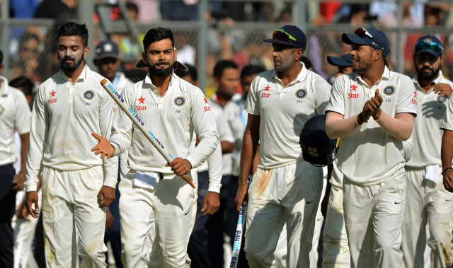 virat kohli 2l celebrates with his teammates at the wankhede stadium in mumbai on december 12 2016 photo afp