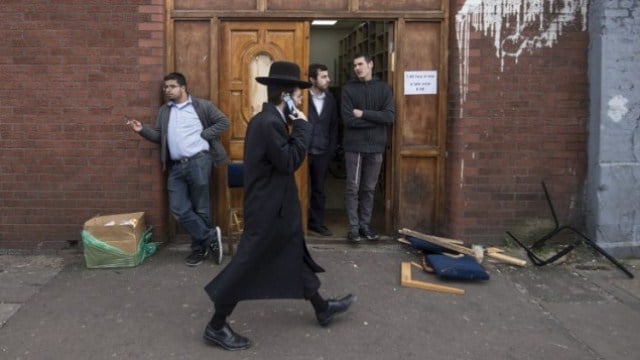 illustrative photo of an orthodox jew walking past the ahavas torah synagogue in the stamford hill area of north london on march 22 2015 photo afp