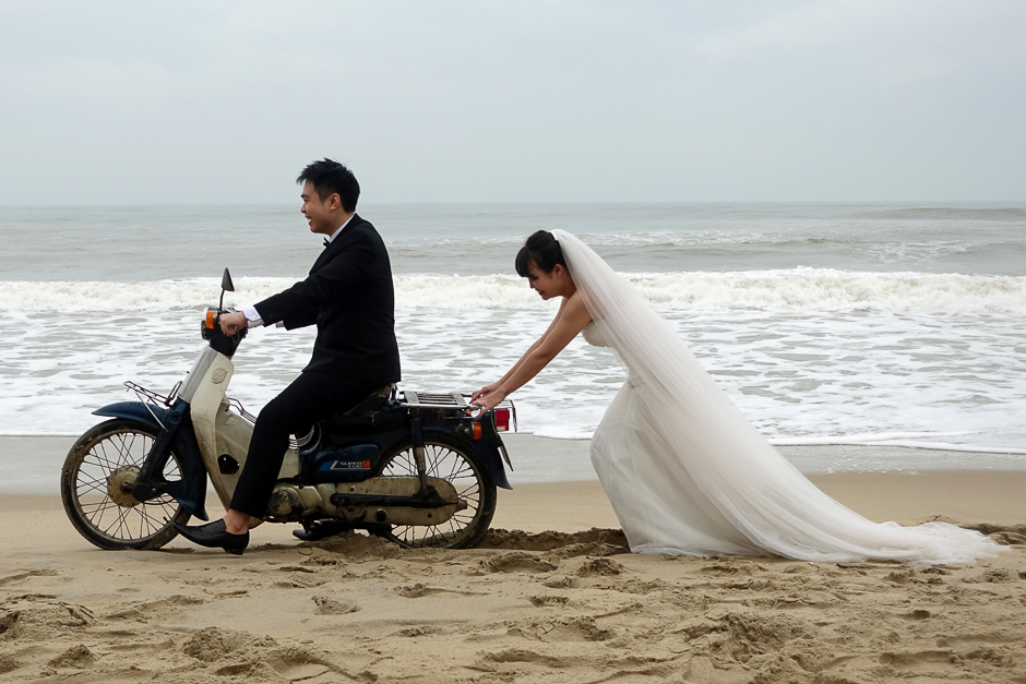 a vietnamese bride is seen pushing the groom on a scooter during a photo shoot for their wedding in an bang beach outside hoi an in vietnam photo reuters