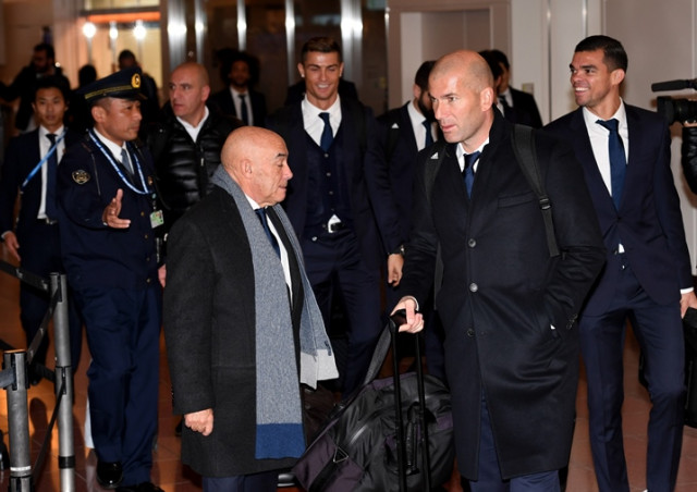 spanish football club real madrid head coach zinedine zidane of france 2nd r walks with his players upon their arrival at the haneda international airport in tokyo on december 12 2016 more than 300 fans welcomed real madrid team which had been here to compete in the club world cup tournament photo afp spanish football club real madrid head coach zinedine zidane of france 2nd r walks with his players upon their arrival at the haneda international airport in tokyo on december 12 2016 more than 300 fans welcomed real madrid team which had been here to compete in the club world cup tournament photo afp