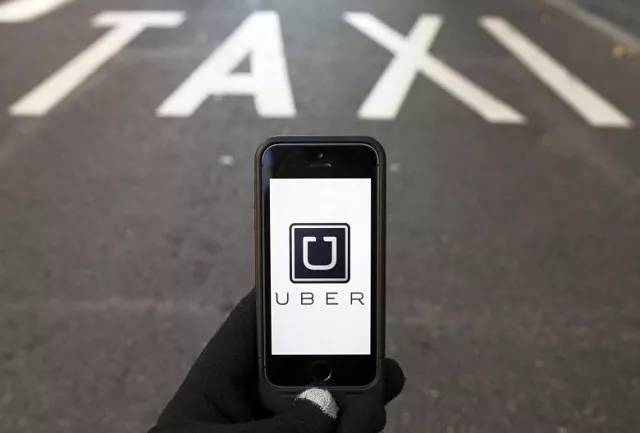 the logo of car sharing service app uber on a smartphone photo reuters the logo of car sharing service app uber on a smartphone photo reuters