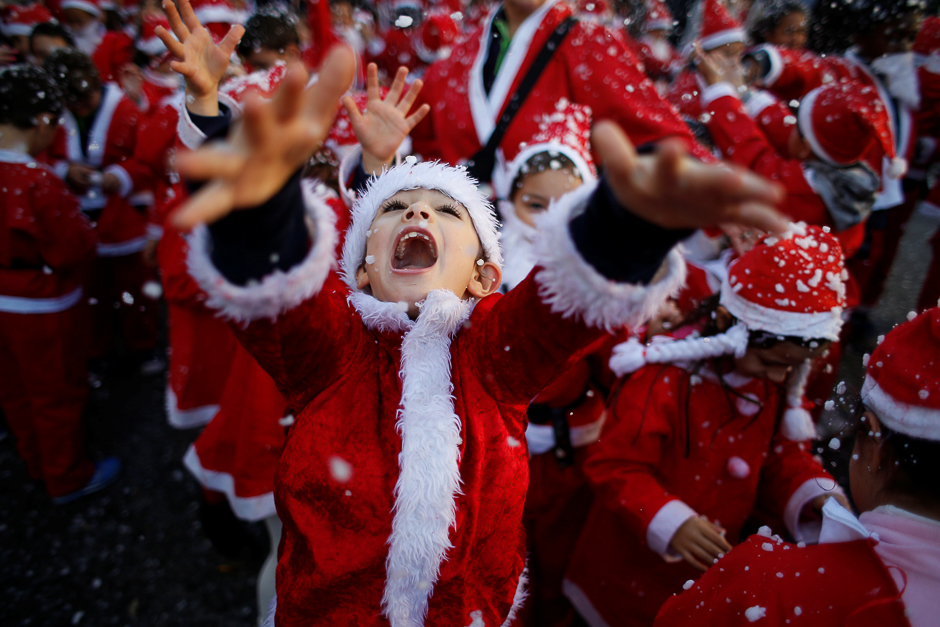 children dressed as santa claus participate in a parade held to collect food for the needy in lisbon portugal photo reuters