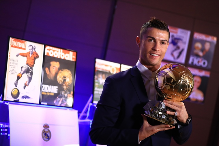 handout photo released on december 12 2016 by l 039 equipe shows portugese player cristiano ronaldo posing with the ballon d 039 or france football trophy in madrid cristiano ronaldo was named winner of the ballon d 039 or on december 12 2016 for the fourth time organisers france football said capping a terrific year for the real madrid star photo afp