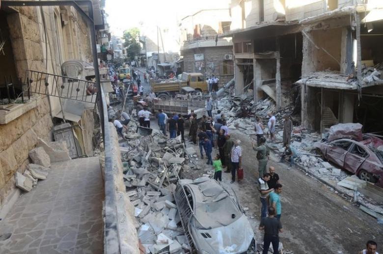 people inspect the damage at a site after it was hit by shelling carried out by rebels at syrian government held areas of aleppo syria in this handout picture provided by sana on july 11 2016 sana handout via reuters