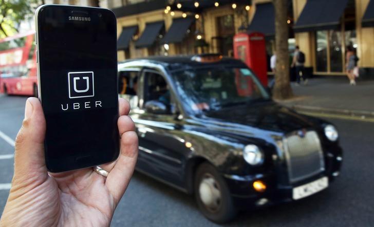 a photo illustration shows the uber app logo displayed on a mobile telephone photo reuters