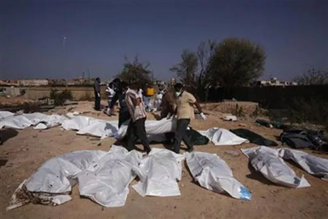 volunteers carry a body as they try to identify 26 exhumed bodies found in unknown graves photo reuters volunteers carry a body as they try to identify 26 exhumed bodies found in unknown graves photo reuters