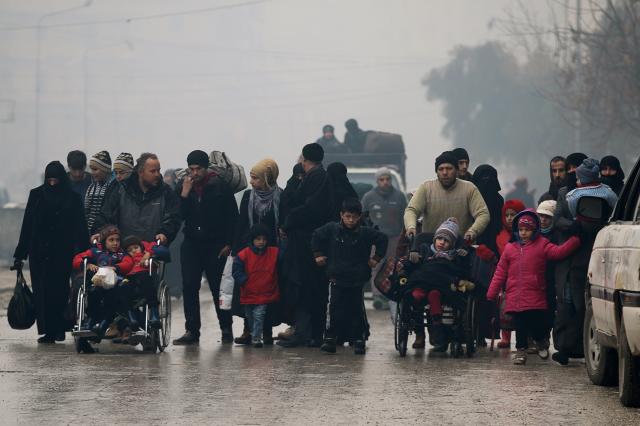 people walk as they flee deeper into the remaining rebel held areas of aleppo syria december 13 2016 photo reuters