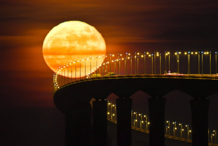 a full moon rising over the re island bridge in rivedoux photo afp