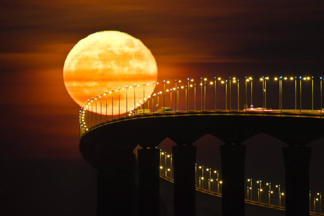 a full moon rising over the re island bridge in rivedoux photo afp