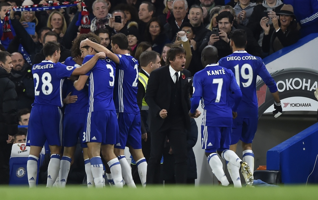 eden hazard celebrates scoring their first goal with teammates and manager antonio conte photo reuters