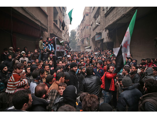 syrian demonstrators gather in the rebel held town of saqba on the eastern outskirts of the capital damascus during a demonstration in solidarity with the inhabitants of the embattled syrian city of aleppo on december 16 2016 photo afp