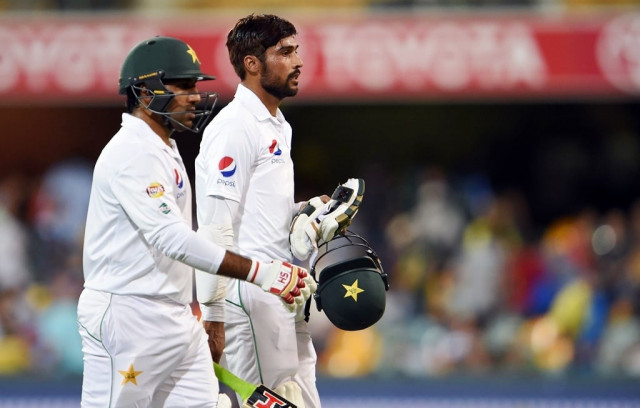sarfraz and amir somehow saw off the pink ball under lights on day two photo afp sarfraz and amir somehow saw off the pink ball under lights on day two photo afp