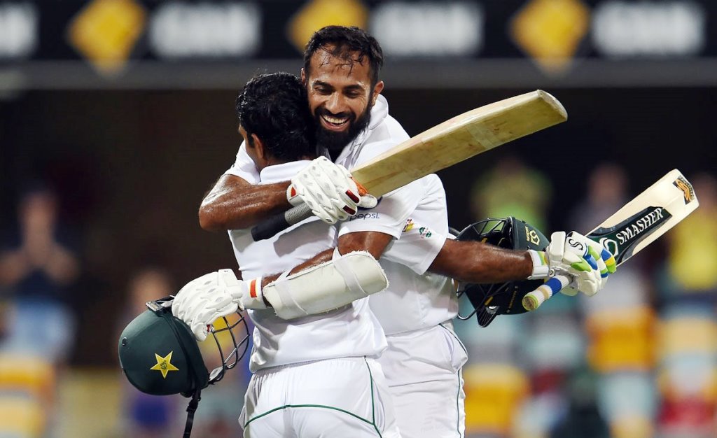 bear hugs wahab congratulates shafiq on completing his century photo afp