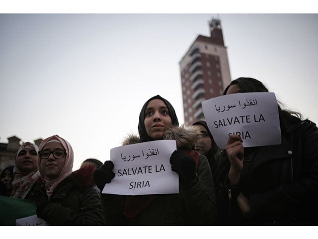 people hold placards reading quot save syria quot during a demonstration in support of the people of the syrian city of aleppo on piazza castello on december 18 2016 in turin photo afp