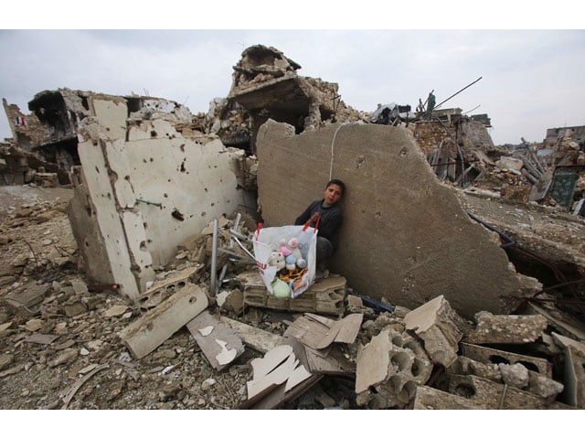 a syrian boy sits with belongings he collected from the rubble of his house in aleppo 039 s al arkoub neighbourhood on december 17 2016 after pro government forces retook the area from rebel fighters photo afp