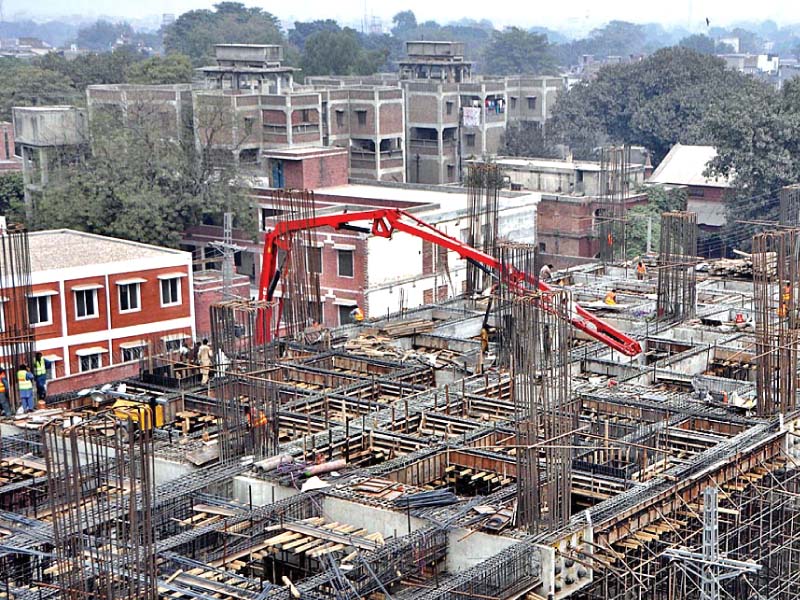 workers busy in construction of a flyover for metro train s orange line photo file