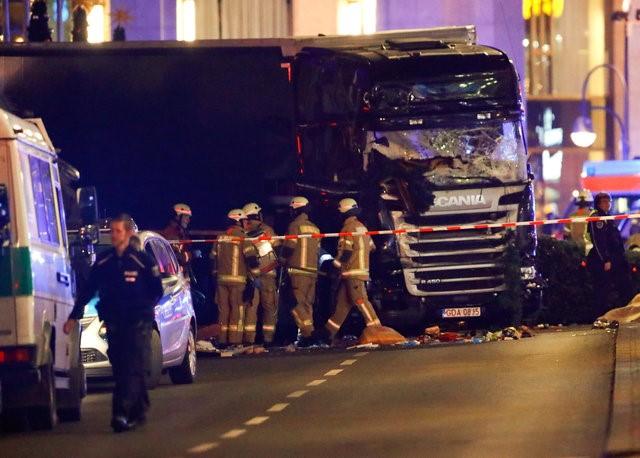 police and emergency workers stand next to a crashed truck at the site of an accident at a christmas market on breitscheidplatz square near the fashionable kurfuerstendamm avenue in the west of berlin germany december 19 2016 photo reuters