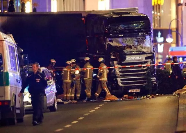 police and emergency workers stand next to a crashed truck at the site of an accident at a christmas market on breitscheidplatz square near the fashionable kurfuerstendamm avenue in the west of berlin germany december 19 2016 photo reuters police and emergency workers stand next to a crashed truck at the site of an accident at a christmas market on breitscheidplatz square near the fashionable kurfuerstendamm avenue in the west of berlin germany december 19 2016 photo reuters