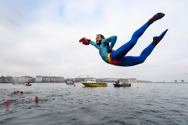 a swimmer disguised as superman dives into the lake during the 78th quot coupe de noel quot christmas cup swimming race in the lake geneva photo afp