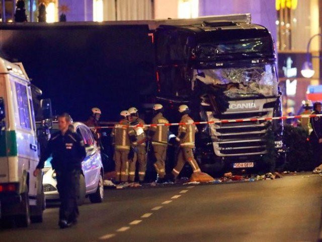 police and emergency workers stand next to a crashed truck at the site of an accident at a christmas market on breitscheidplatz square near the fashionable kurfuerstendamm avenue in the west of berlin germany december 19 2016 photo reuters