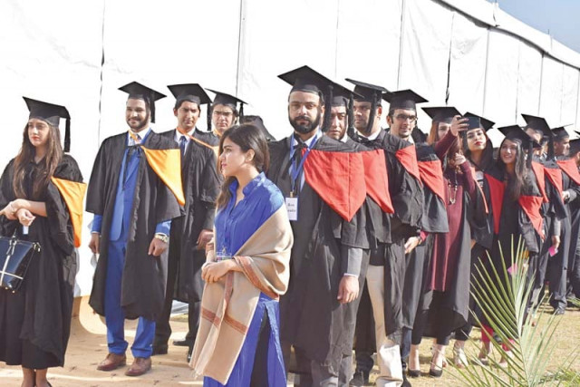 graduating students line up to receive their degrees at the convocation photo express graduating students line up to receive their degrees at the convocation photo express