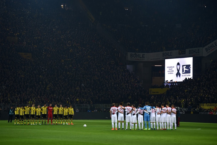 dortmund 039 s and augsburg 039 s players stand for a minute of silence for the victims of the berlin attack prior to the german first division bundesliga football match between borussia dortmund and fc augsburg in dortmund western germany on december 20 2016 photo afp