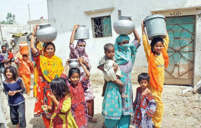 women carrying pots full of water on their heads due to the acute shortage of water in the ibrahim hyderi locality of the metropolis photo file women carrying pots full of water on their heads due to the acute shortage of water in the ibrahim hyderi locality of the metropolis photo file