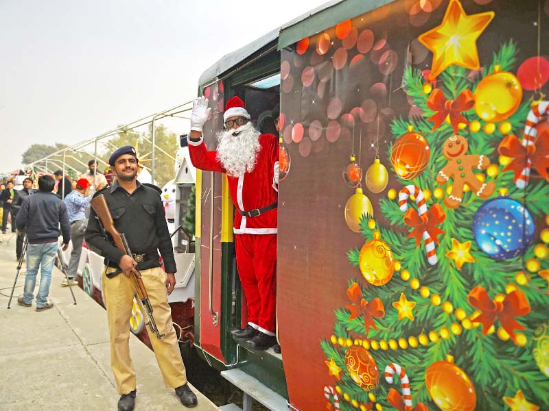 a man dressed as santa claus waves from the christmas peace train after its inauguration ceremony in islamabad photo afp