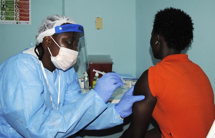 a health worker injects a woman with an ebola vaccine during a trial in monrovia february 2 2015 photo reuters