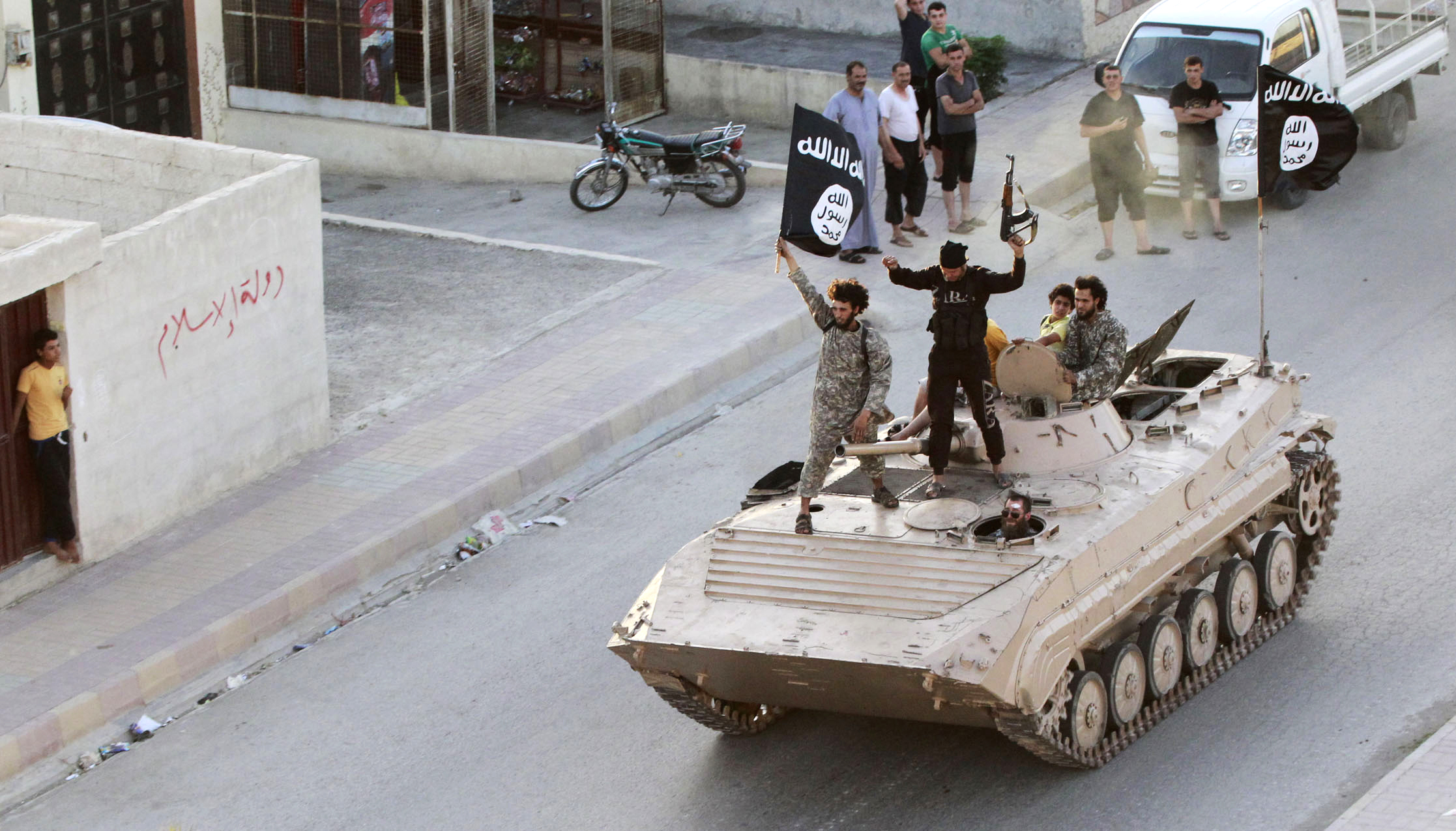 militants fighters take part in a military parade along the streets of northern raqqa province photo reuters