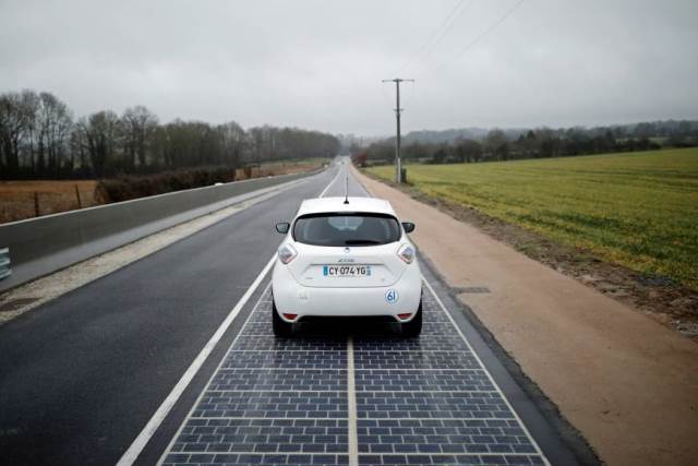 an automobile drives on a solar road during its inauguration in tourouvre france on thursday photo reuters