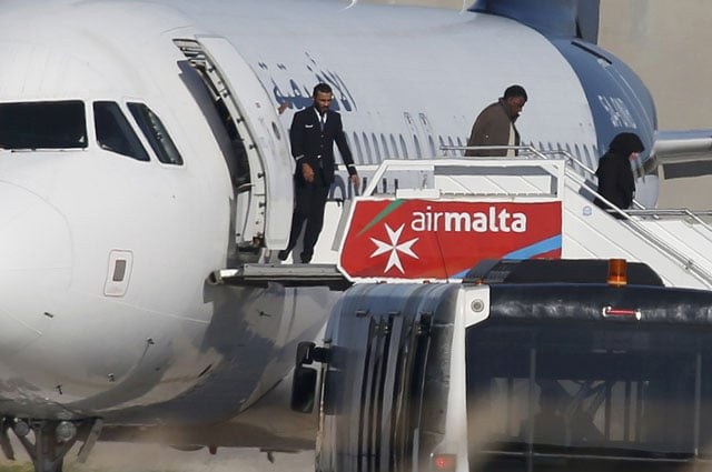 people disembark from a hijacked libyan afriqiyah airways airbus a320 on the runway at malta airport december 23 2016 photo reuters