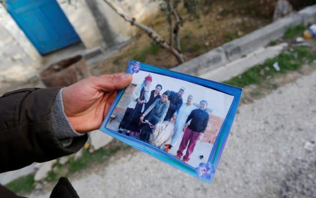 brother of the berlin christmas market truck attack suspect anis amri shows a picture of anis amri c in oueslatia tunisia photo reuters