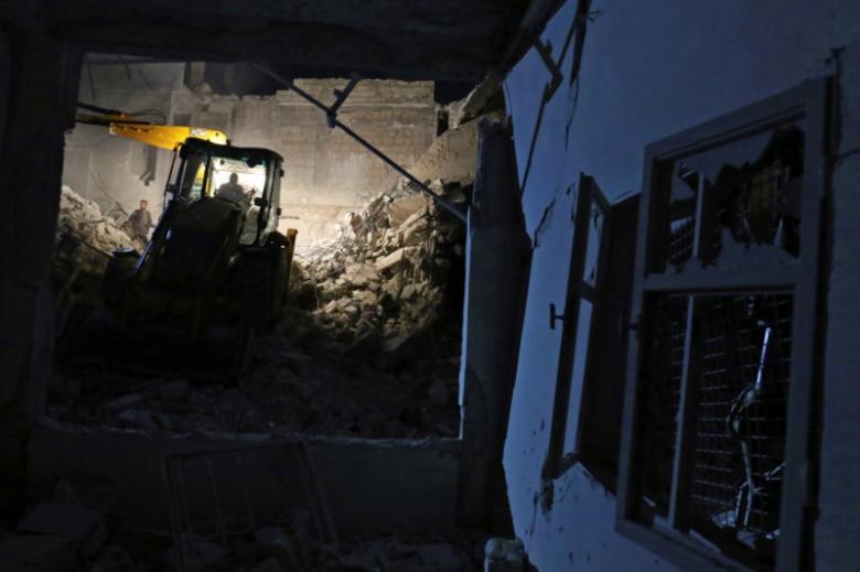 civil defence members work at a site hit at night by an airstrike in saraqeb photo reuters