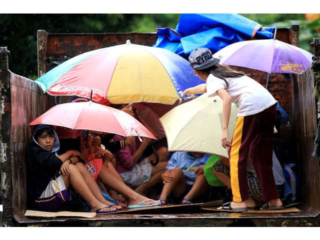 young residents sit in a truck after the local government implemented preemptive evacuations at barangay matnog daraga albay province on december 25 2016 due to the approaching typhoon nock ten photo afp young residents sit in a truck after the local government implemented preemptive evacuations at barangay matnog daraga albay province on december 25 2016 due to the approaching typhoon nock ten photo afp