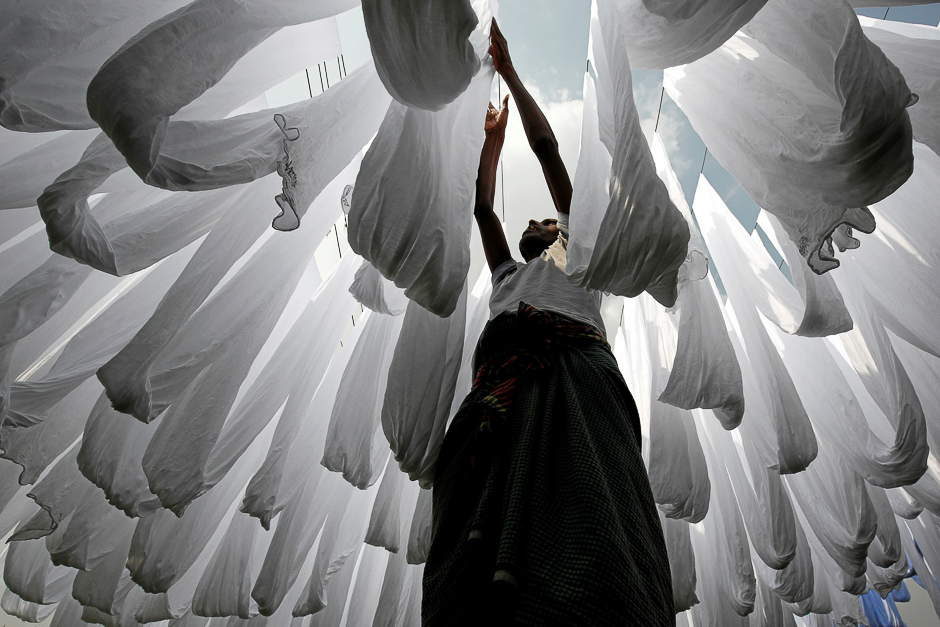 a dye factory worker suns fabric after washing them in narayanganj near dhaka bangladesh photo reuters a dye factory worker suns fabric after washing them in narayanganj near dhaka bangladesh photo reuters