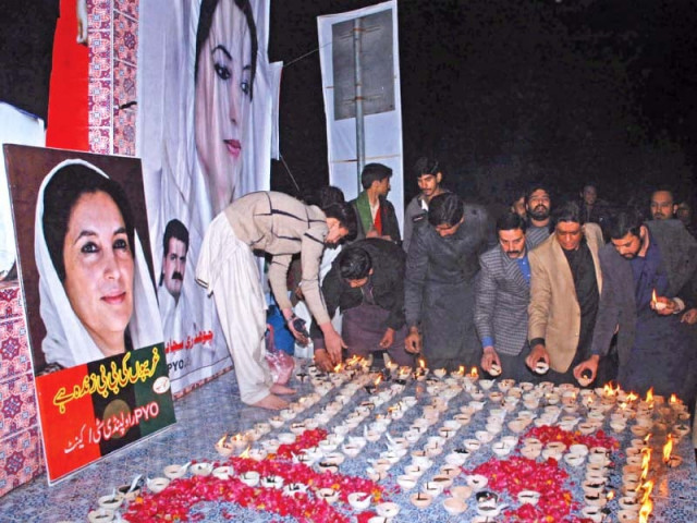 ppp workers burn lamps at the memorial of benazir bhutto photo zafar aslam express ppp workers burn lamps at the memorial of benazir bhutto photo zafar aslam express