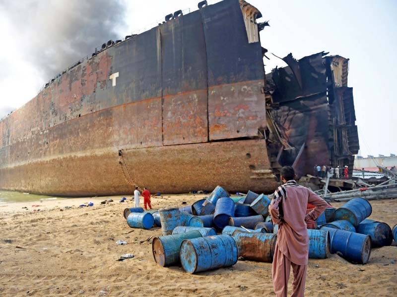 a man looks at the wreckage of the ship which caught fire at the gadani ship breaking yard on november 1 photo file