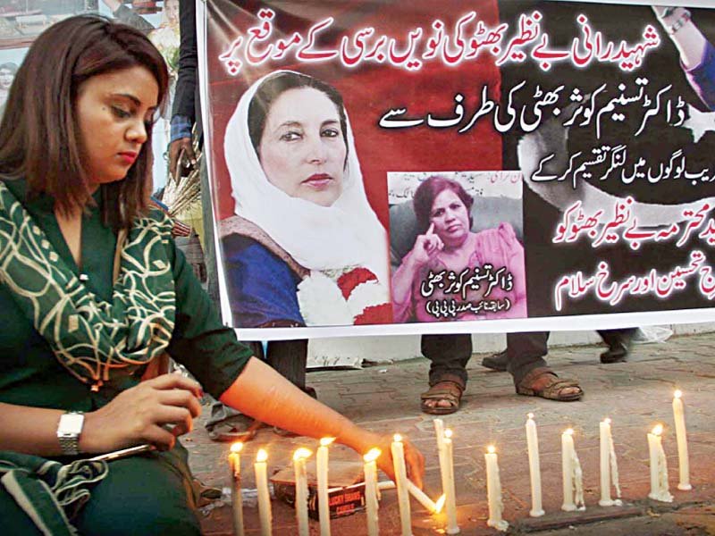 a pakistan peoples party worker lights candles outside karachi press club on the eve of slain party leader benazir bhutto s death anniversary photo online