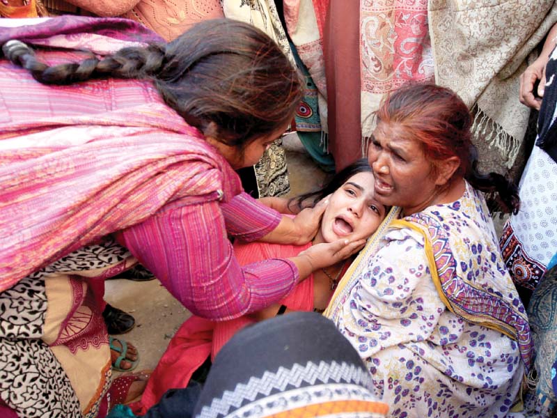 a woman is comforted by others as she mourns the death of a relative who died after consuming toxic liquor in toba tek singh photo reuters