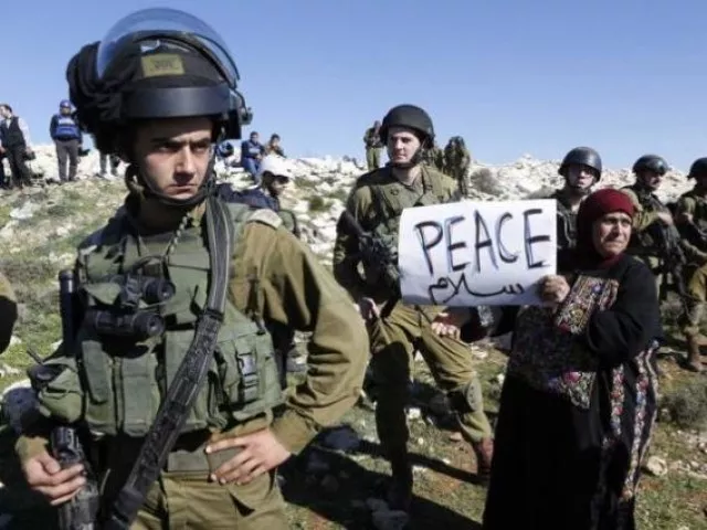 a palestinian protesting for peace next to israeli soldiers photo reuters a palestinian protesting for peace next to israeli soldiers photo reuters