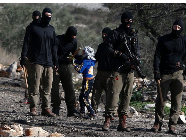 masked members of the israeli security forces briefly detain a palestinian boy during clashes following a demonstration against the expropriation of palestinian land by israel in the village of kfar qaddum near nablus in the occupied west bank on december 23 2016 photo afp masked members of the israeli security forces briefly detain a palestinian boy during clashes following a demonstration against the expropriation of palestinian land by israel in the village of kfar qaddum near nablus in the occupied west bank on december 23 2016 photo afp