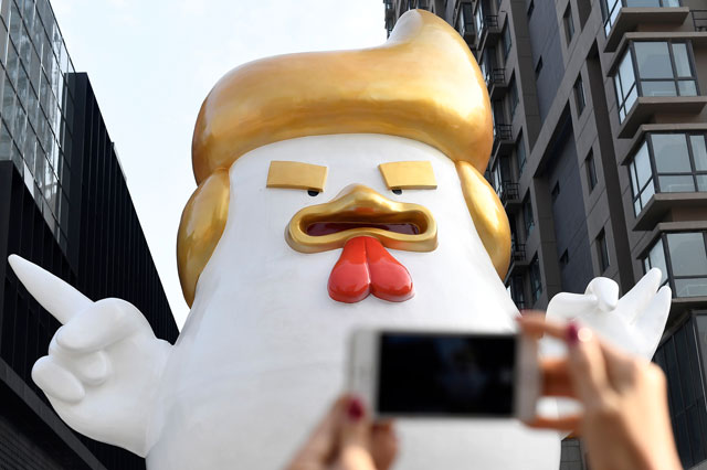 a chinese shopping mall is ringing in the year of the cock with a giant sculpture of a chicken that looks like us president elect donald trump photo afp