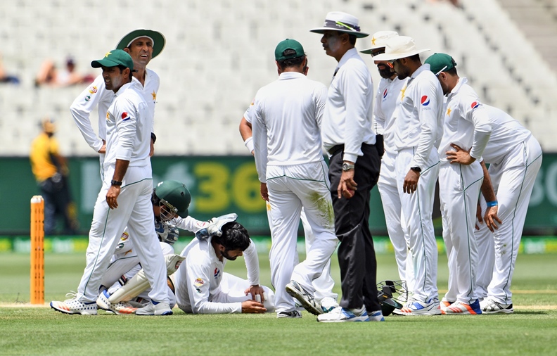 pakistan fieldsman azhar ali 4th l lies on the ground after being hit in the head by a pull shot from australia 039 s batsman matthew wade on the fourth day of the second cricket test match in melbourne on december 29 2016 photo afp