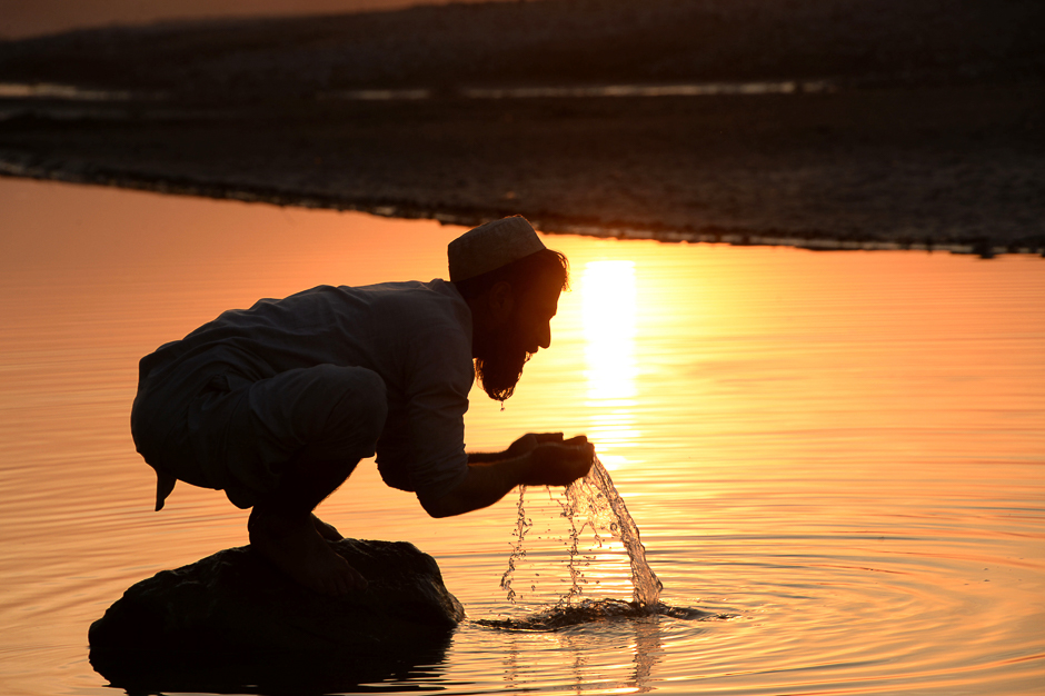 an afghan man performs ablution before prayers in a river on the outskirts of jalalabad photo afp