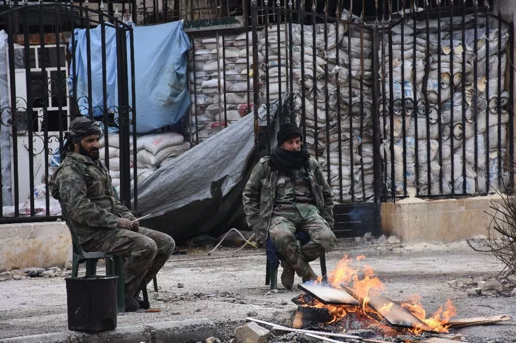 syrians soldiers sit by a fire in the former rebel held ansari district of aleppo on december 23 2016 photo afp syrians soldiers sit by a fire in the former rebel held ansari district of aleppo on december 23 2016 photo afp